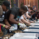 Oyster growers take part in a shucking competition at an event to raise money for oyster restoration.
